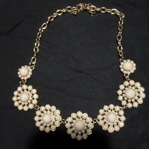 Women’s white and gold floral style necklace. Great statement piece to wear